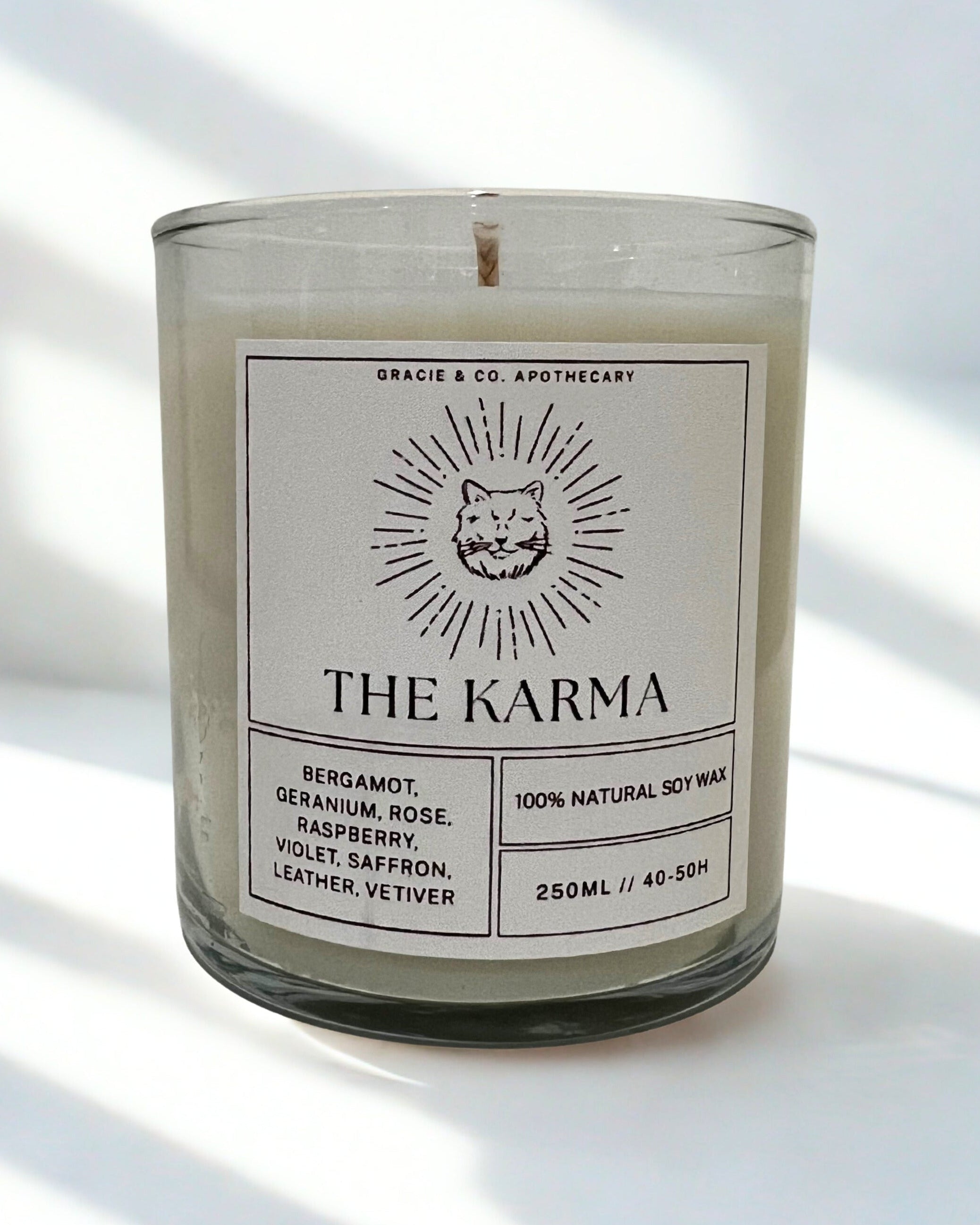 Candle labeled 'The Karma' with a label featuring a fox illustration on a light background