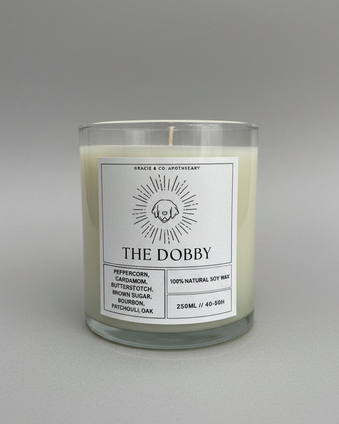 Candle labeled 'The Dobby' on a white background
