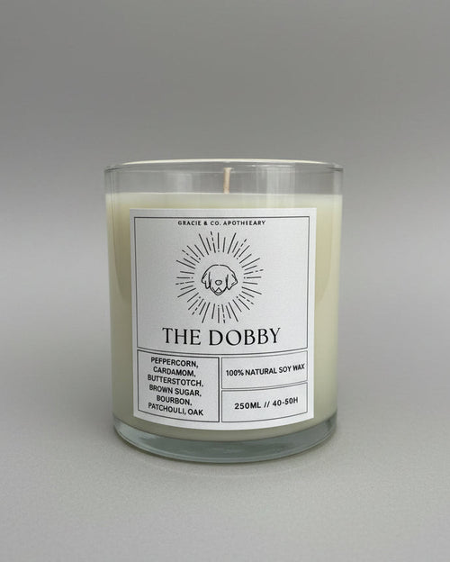 Candle labeled 'The Dobby' on a white background